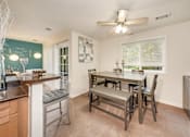 Thumbnail 7 of 32 - A kitchen with a dining table and chairs.