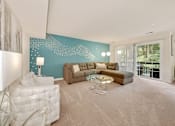 Thumbnail 2 of 32 - A living room with a white sofa and a glass coffee table.