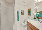 Thumbnail 11 of 32 - A bathroom with a toilet, sink, and shower.