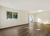 Thumbnail 1 of 32 - A room with a window and sliding glass door.