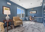 Thumbnail 21 of 42 - A room with blue walls and a striped chair.