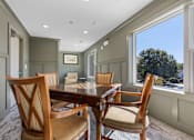 Thumbnail 20 of 42 - A dining room with a wooden table and chairs.