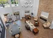 Thumbnail 10 of 42 - A living room with a brick wall and a fireplace.