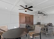 Thumbnail 29 of 42 - A room with a table and chairs and a ceiling fan.