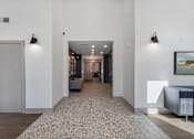 Thumbnail 30 of 42 - A hallway with a carpeted floor and a painting on the wall.