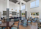 Thumbnail 13 of 42 - A modern dining room with a long table and chairs.