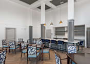 Thumbnail 14 of 42 - A dining room with a table surrounded by chairs.