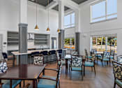 Thumbnail 23 of 42 - A modern dining room with a dark wood table and chairs.