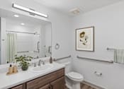 Thumbnail 8 of 42 - A bathroom with a white toilet and a white sink.
