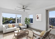 Thumbnail 2 of 42 - A living room with a white couch, a wooden coffee table, and a ceiling fan.