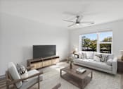 Thumbnail 4 of 42 - A modern living room with a television, sofa, and a wooden coffee table.