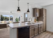 Thumbnail 1 of 42 - A modern kitchen with a large island and wooden cabinets.