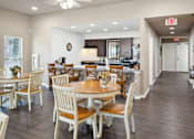 Thumbnail 7 of 14 - A dining room with a table set for six.