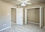 Thumbnail 2 of 14 - A room with a white door and a white closet with a hanger.