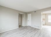 Thumbnail 7 of 13 - A room with a white door and a window with blinds.