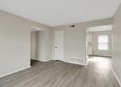 Thumbnail 8 of 13 - A room with light wood flooring and white walls.