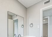 Thumbnail 6 of 13 - A bathroom with a white sink and a mirror.