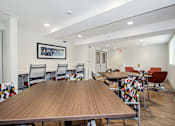 Thumbnail 8 of 30 - a communal dining room with tables and chairs at the addison apartments