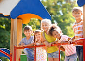 Thumbnail 2 of 4 - Children playing on a playground slide.