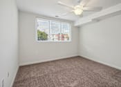 Thumbnail 5 of 30 - an empty bedroom with a ceiling fan and a window