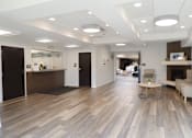 Thumbnail 16 of 22 - A spacious office with wood flooring and white walls.