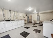 Thumbnail 11 of 12 - a large kitchen with white appliances and counters and white walls