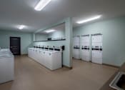 Thumbnail 20 of 20 - the laundry room is equipped with washers and dryers and a row of sinks