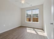 Thumbnail 8 of 20 - an empty room with wood floors and a window