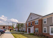 Thumbnail 2 of 20 - a row of houses on the side of a sidewalk