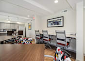 Thumbnail 27 of 30 - a conference room with a table and chairs and a kitchen