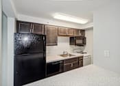 Thumbnail 10 of 30 - a kitchen with a black refrigerator and a sink