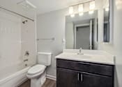 Thumbnail 18 of 30 - a bathroom with a sink toilet and a mirror