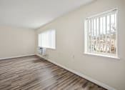 Thumbnail 3 of 12 - a living room with hardwood floors and a large window