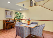 Thumbnail 5 of 24 - a dining room with a table and chairs and a piano