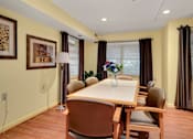 Thumbnail 11 of 24 - a dining room with a table and chairs
