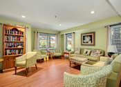 Thumbnail 9 of 24 - a living room filled with furniture and a book shelf