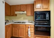 Thumbnail 7 of 24 - a kitchen with a stove and a black oven