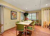 Thumbnail 16 of 24 - a dining room with a table and chairs