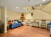 Thumbnail 12 of 24 - a living room with a couch and a table and a christmas tree