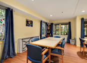 Thumbnail 14 of 24 - a dining room with a table and chairs