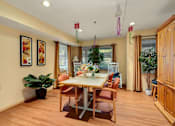 Thumbnail 6 of 24 - a dining room with a table and chairs