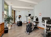 Thumbnail 24 of 24 - a gym with various exercise machines on the floor and a window