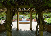Thumbnail 21 of 24 - a gazebo with a fountain in the middle of a courtyard