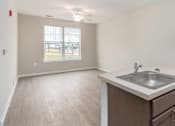 Thumbnail 7 of 20 - an empty kitchen with a sink and a window