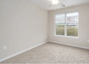 Thumbnail 9 of 20 - an empty room with a window and carpet