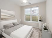 Thumbnail 4 of 20 - a white bedroom with a white bed and a window