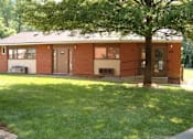 Thumbnail 1 of 2 - a small brick house with a tree in the yard