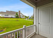 Thumbnail 6 of 19 - A white door is on the porch of a house.