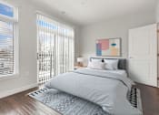 Thumbnail 6 of 18 - A bedroom with a large bed and a painting on the wall.