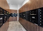 Thumbnail 15 of 18 - A long hallway with mailboxes on the wall.